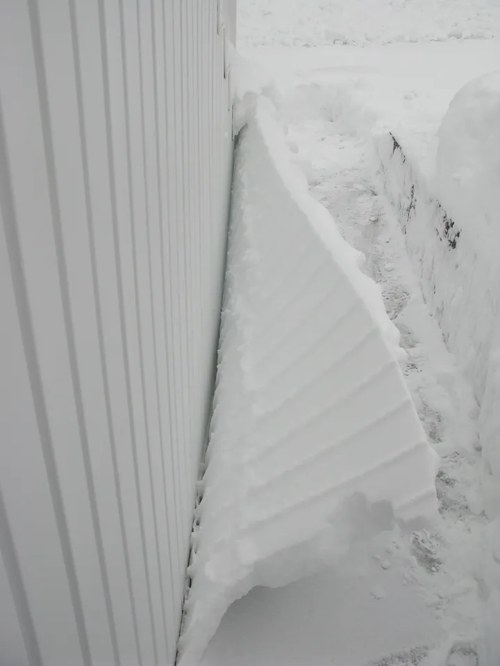 Snow coming away from wall