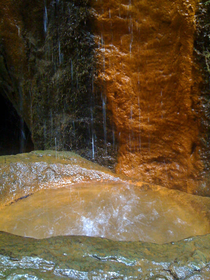 Spring falling into a natural stone basin