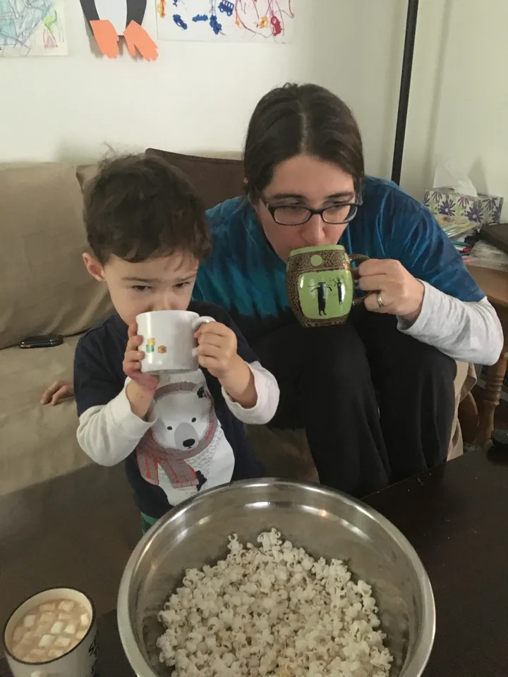 Mom & son enjoying hot cocoa, popcorn, & a movie (not shown)
