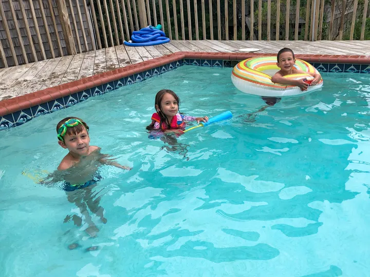 The kids at the beach house pool