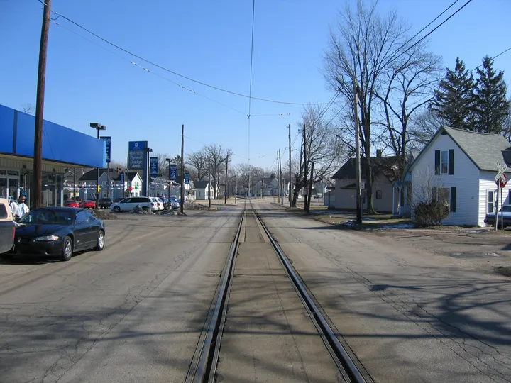 The tracks down the middle of the street.