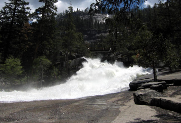 The next bridge, the swollen creek rushing underneath