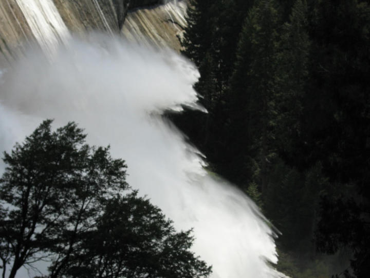 Sheets of spray explode from the waterfall