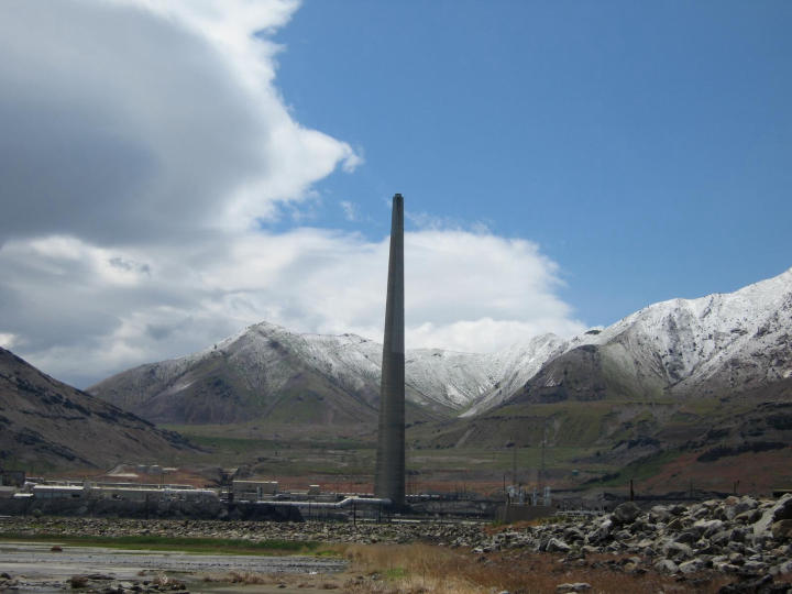 A nearby factory nestled in the mountains