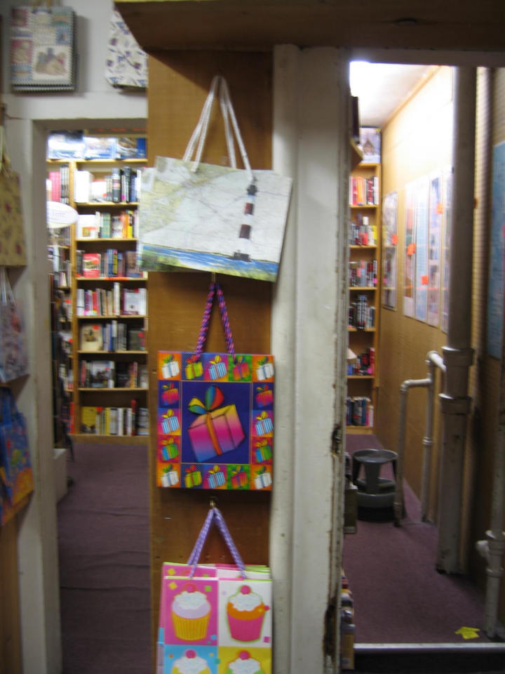 Narrow rooms packed with books.