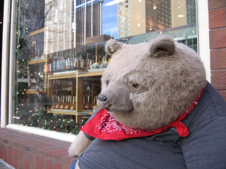 The fat teddy bear outside a candy shop