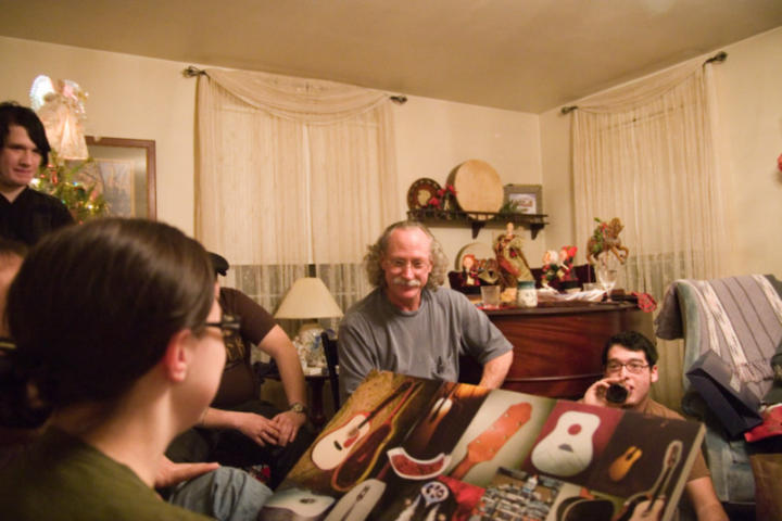 A collage of the guitar that KK (right) is making for him