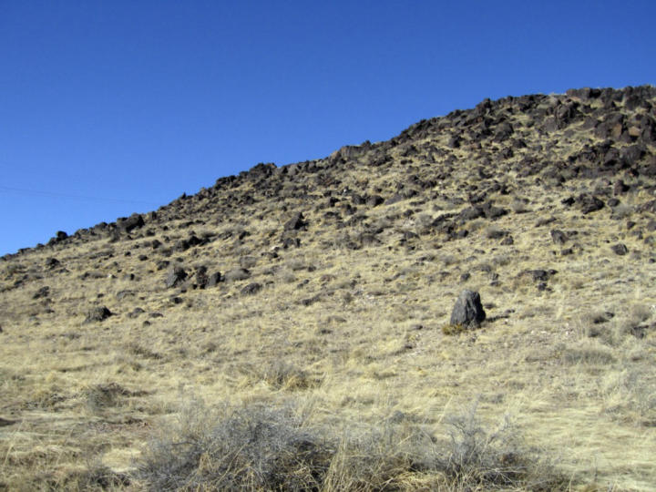 The hillsides are strewn with volcanic rock